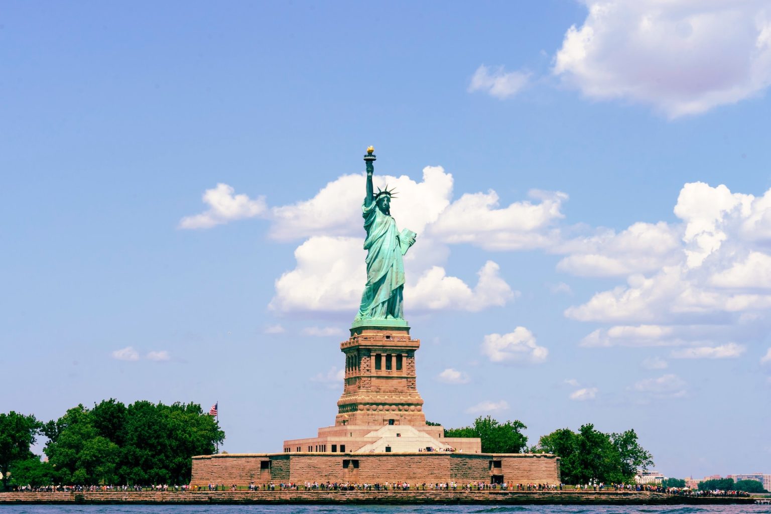 Photo of the statue of liberty taken from the hudson river.