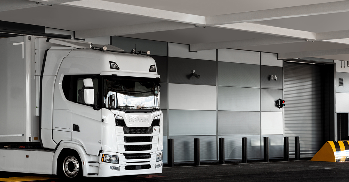 International removals lorry parked in a secure storage warehouse car park.